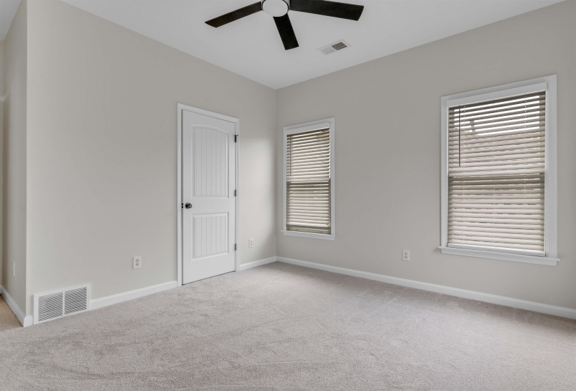Neutral-toned walls complement plush carpeting