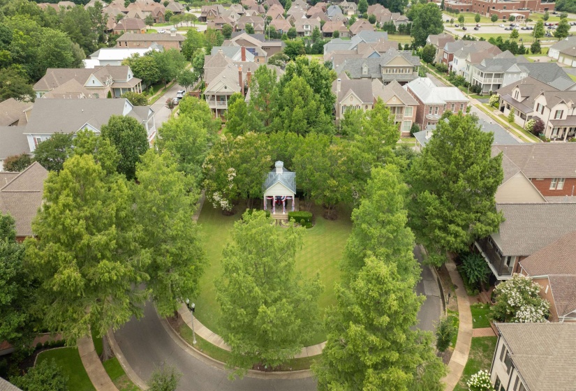 Central community green space featuring a gazebo, surrounded by mature trees and manicured lawn