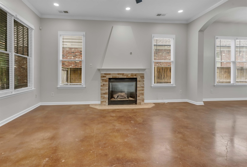 Living area featuring a floor-to-ceiling fireplace with stone surround, a hearth, and an integrated firebox