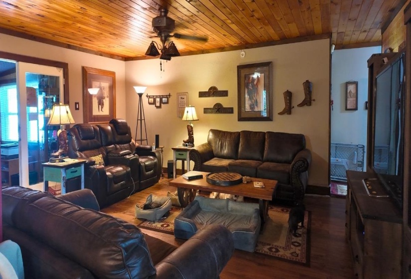 Living space featuring wood-finish flooring and a wood-paneled ceiling