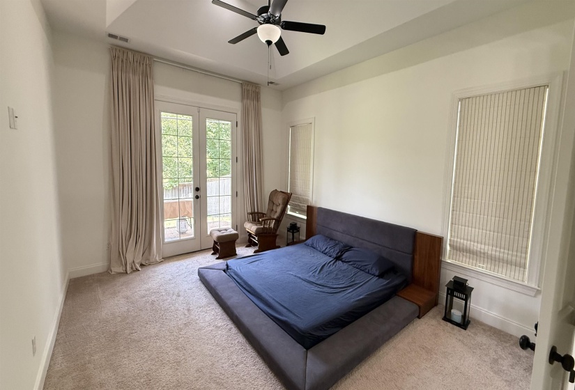 Bedroom featuring carpet flooring, access to exterior, and ceiling fan