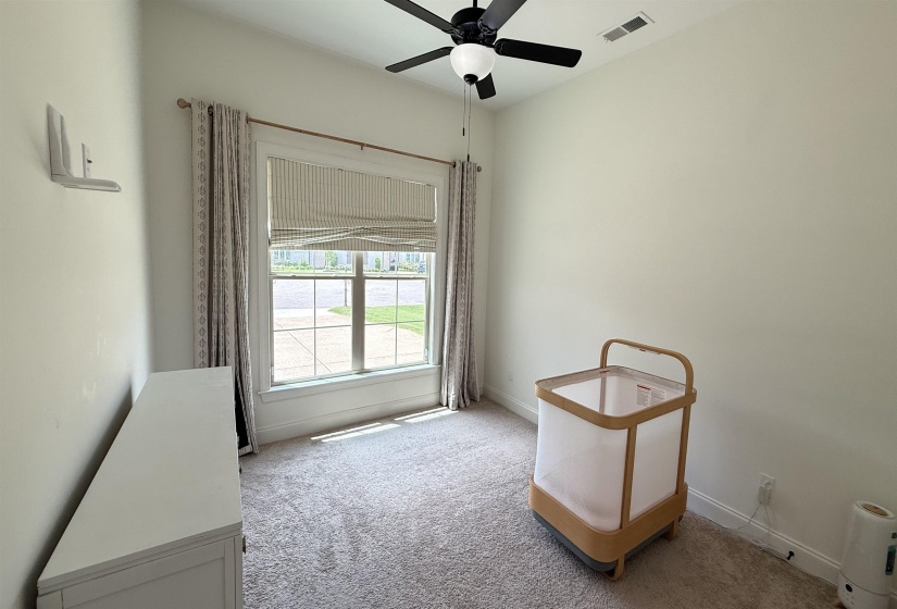 Spare room featuring carpet and ceiling fan