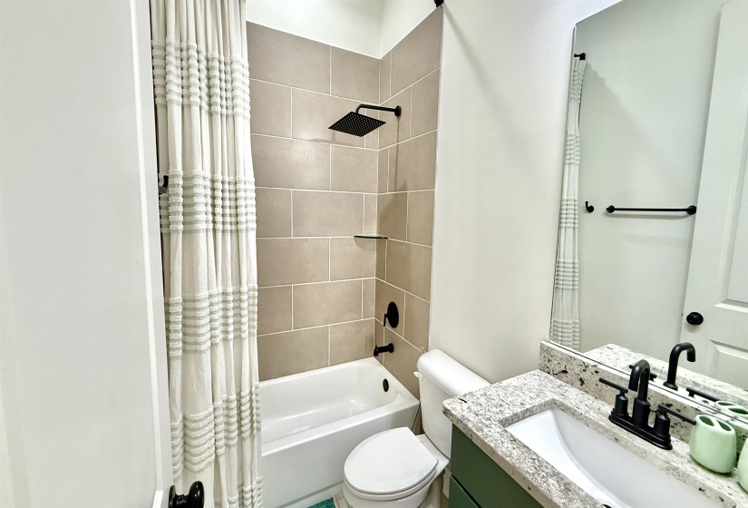 Full bath with shower / bathtub combination with curtain and vanity