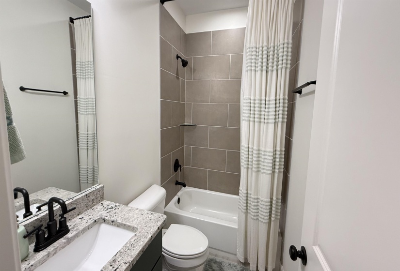 Bathroom with vanity and shower / tub combo