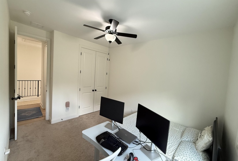 Office space featuring a ceiling fan and carpet floors