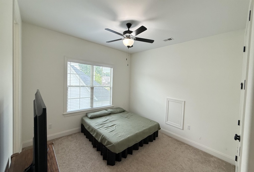 Bedroom with carpet floors and a ceiling fan