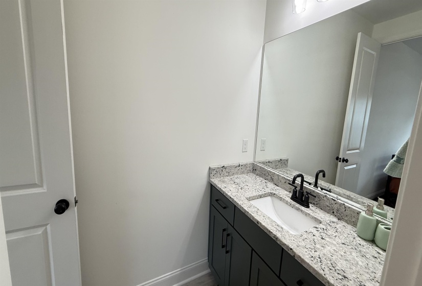 Bathroom featuring vanity and baseboards