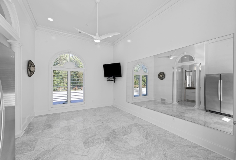 Unfurnished living room featuring ornamental molding, healthy amount of natural light, light marble finish floors, recessed lighting, and ceiling fan