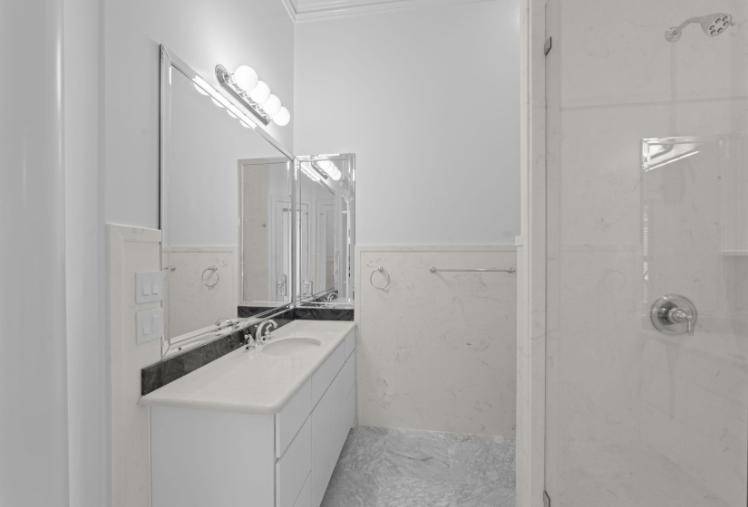 Full bathroom featuring vanity, a shower stall, and tile walls