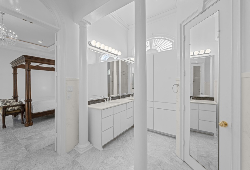 Bathroom featuring ornamental molding, vanity, ensuite bath, and ornate columns