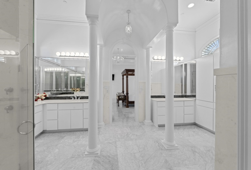 Bathroom featuring ornamental molding, a shower stall, ornate columns, a chandelier, and vanity
