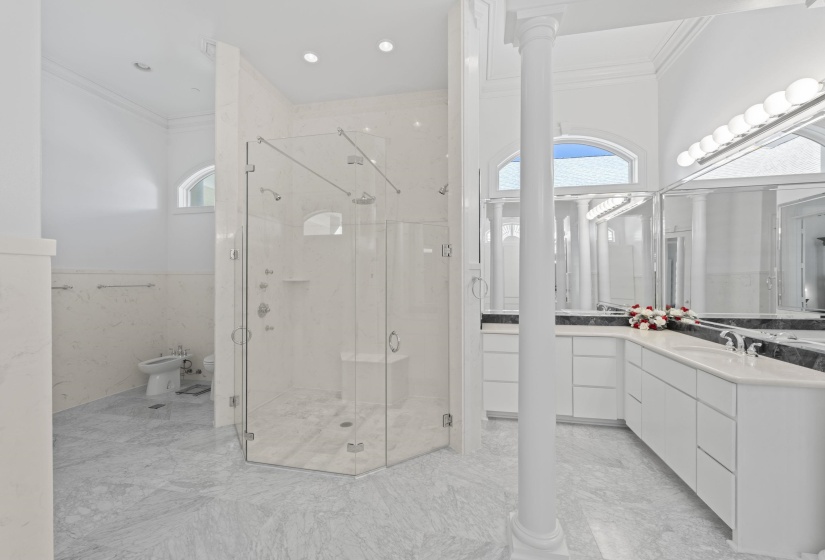 Bathroom featuring ornamental molding, a bidet, vanity, and a shower stall