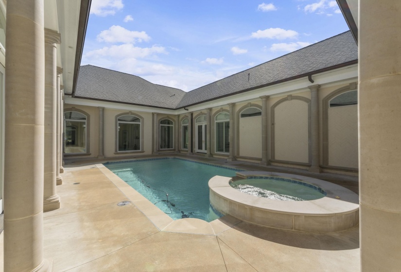 View of pool with a pool with connected hot tub and a patio area
