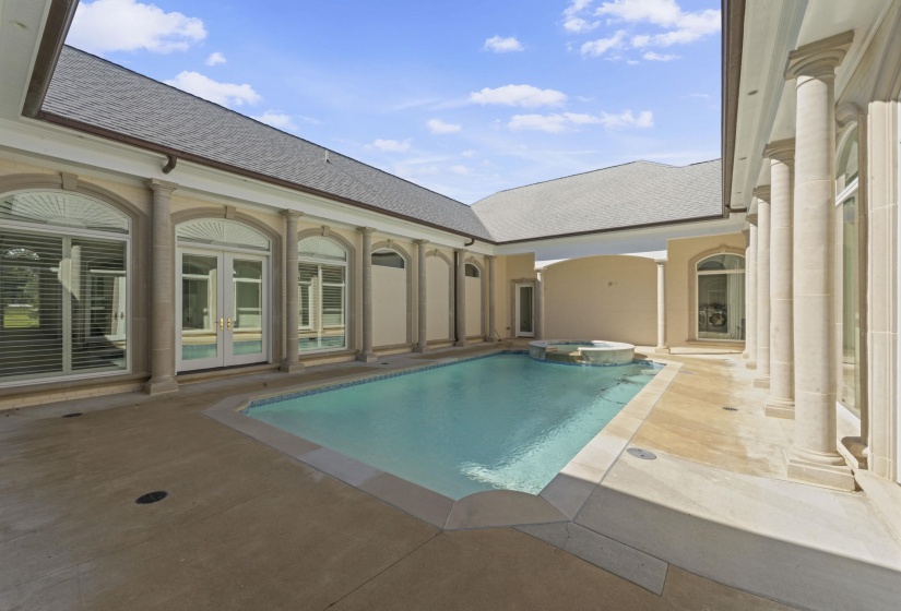 View of pool with a pool with connected hot tub, a patio area, and french doors