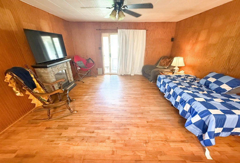 Room featuring wood-finish flooring and wood-paneled walls