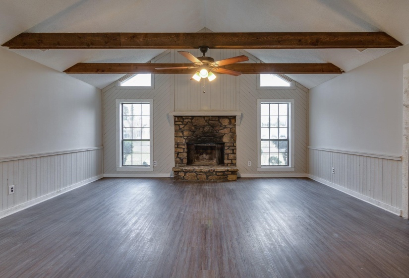 Vaulted ceilings with exposed wood beams define this spacious room