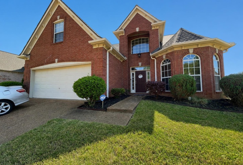 Traditional brick exterior featuring a multi-gabled roofline and prominent architectural details