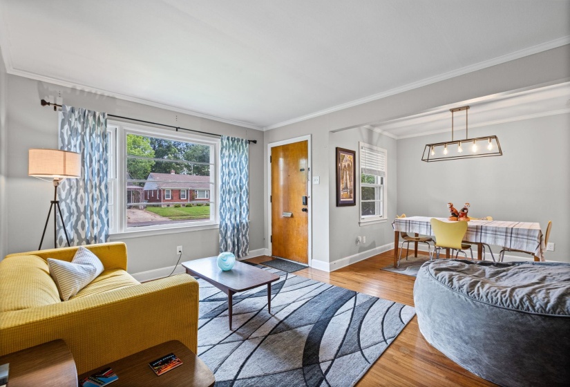 Open concept living area with hardwood flooring and light gray wall paint
