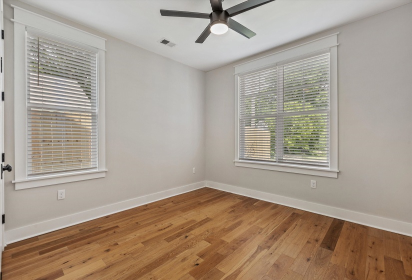 Wood-finish flooring throughout, complemented by light-toned wall paint and white trim