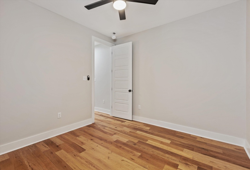 Neutral tone walls with white trim and wood-finish flooring