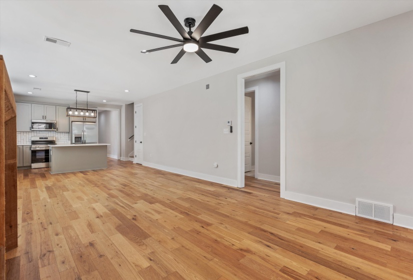 Expansive wood-finish flooring throughout