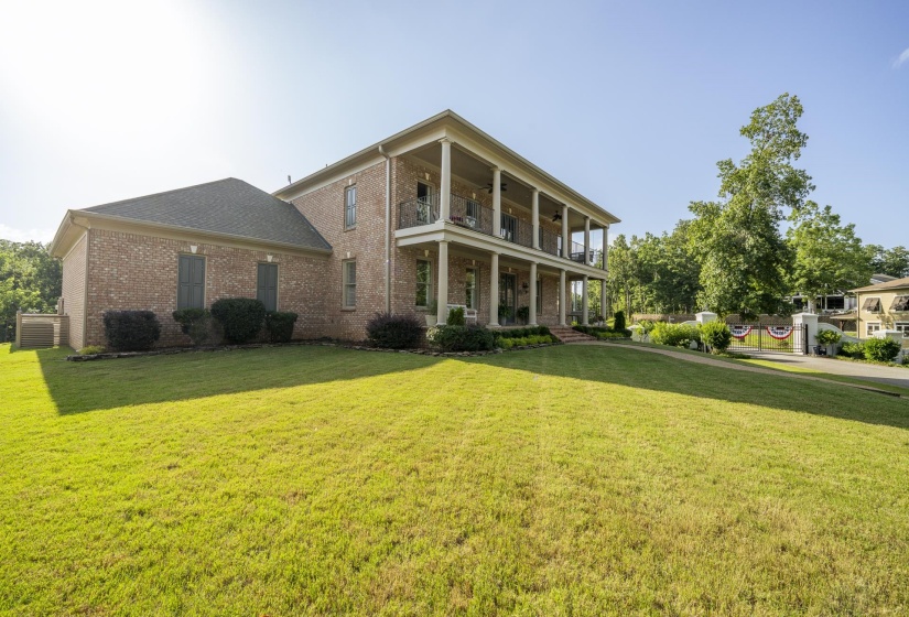 Brick exterior with multi-level covered porches featuring white columns