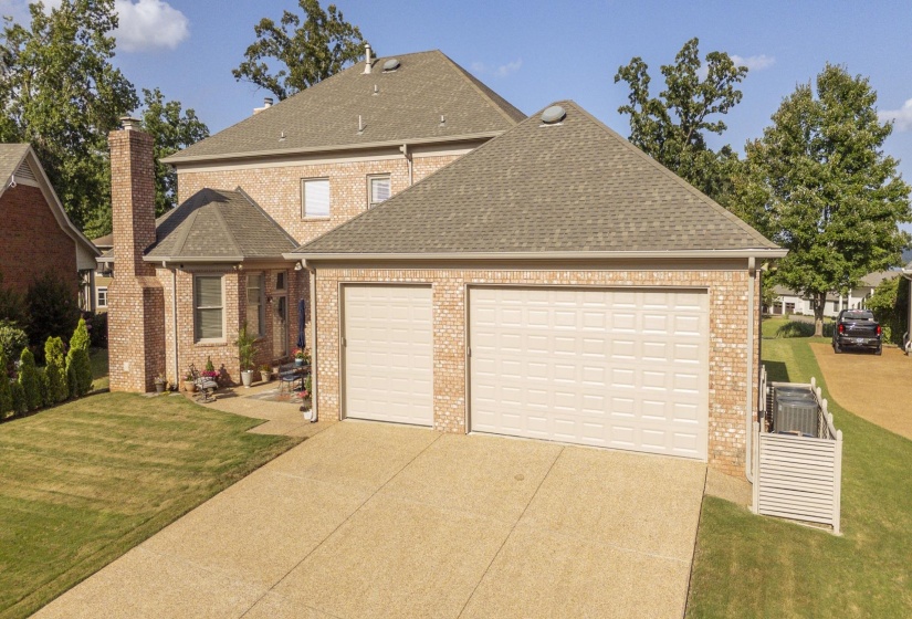Brick exterior with a multi-gabled roofline and attached two-car garage
