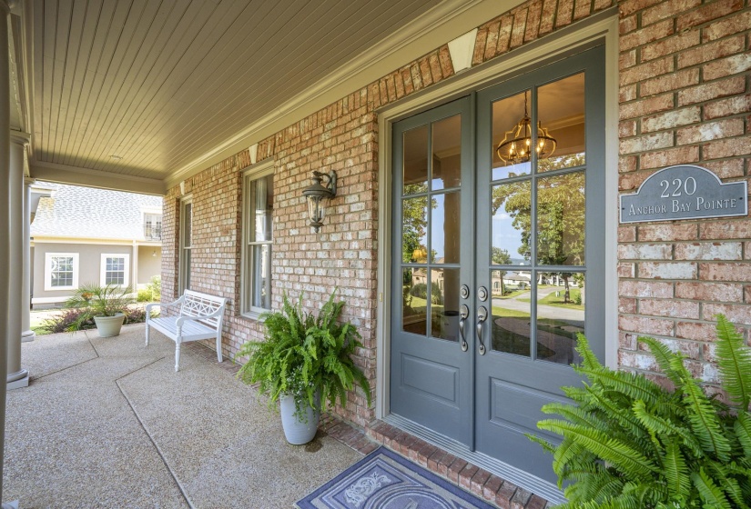 Brick exterior with a covered porch featuring exposed aggregate flooring