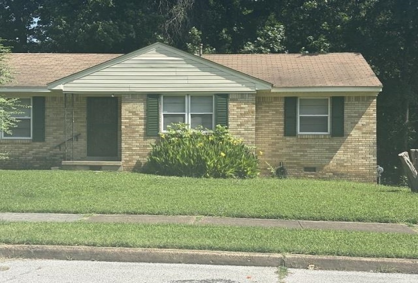 Brick exterior featuring a gabled entry with siding accent