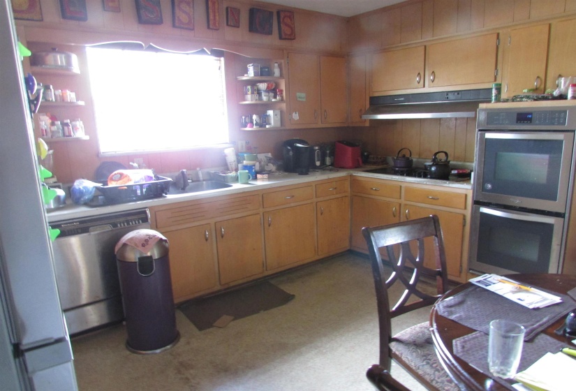 Kitchen featuring wood-finish cabinetry, built-in double ovens, a gas cooktop, and a stainless steel dishwasher