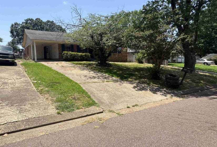 Single-story residence featuring a brick and siding facade, a covered entry, and a concrete driveway