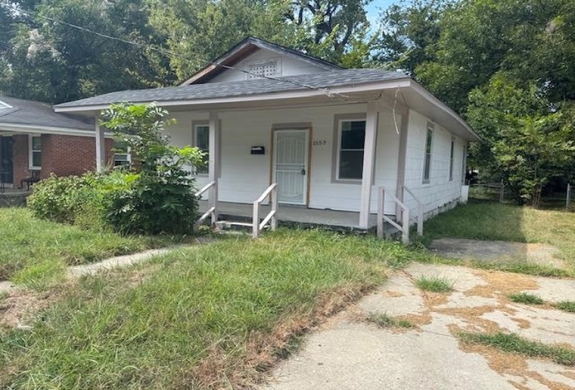 View of front of property featuring a porch and a shingled roof