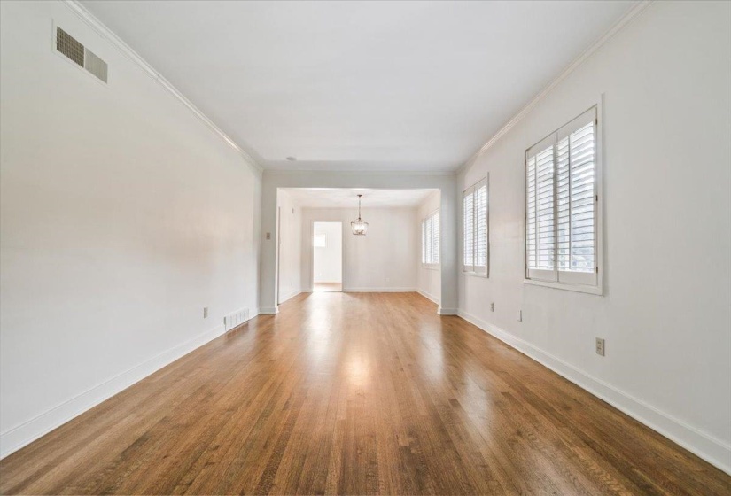 Hardwood flooring spans this expansive room with bright white walls