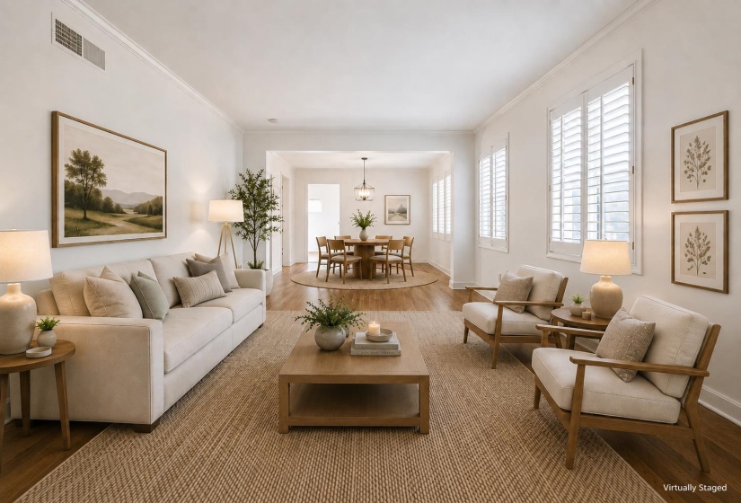 Bright living area featuring wood-finish flooring and crown molding