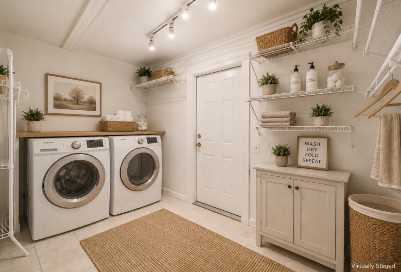 Dedicated laundry area featuring a light wood-finish countertop, track lighting, and tiled flooring