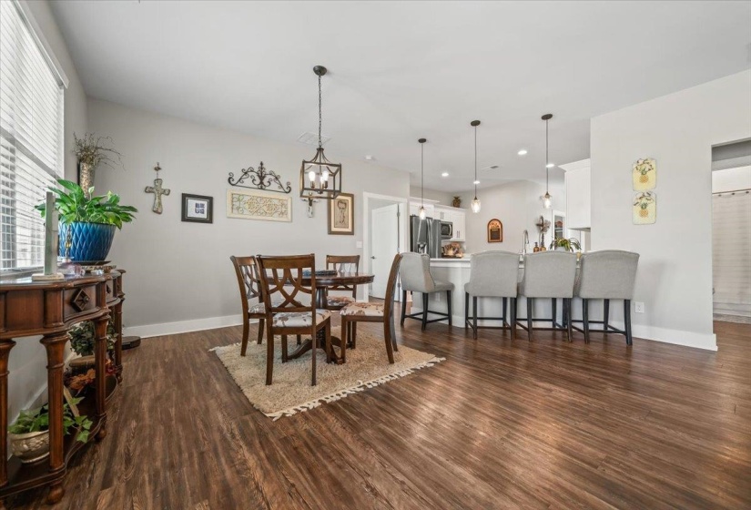 Open-concept living space with wood-finish flooring
