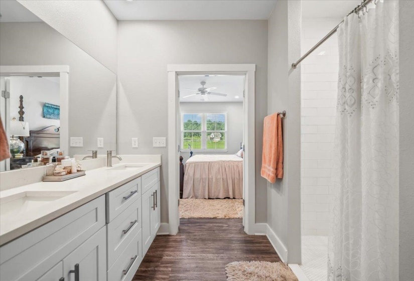 Bathroom featuring a double vanity with light gray cabinetry, light-colored countertops, and brushed nickel fixtures