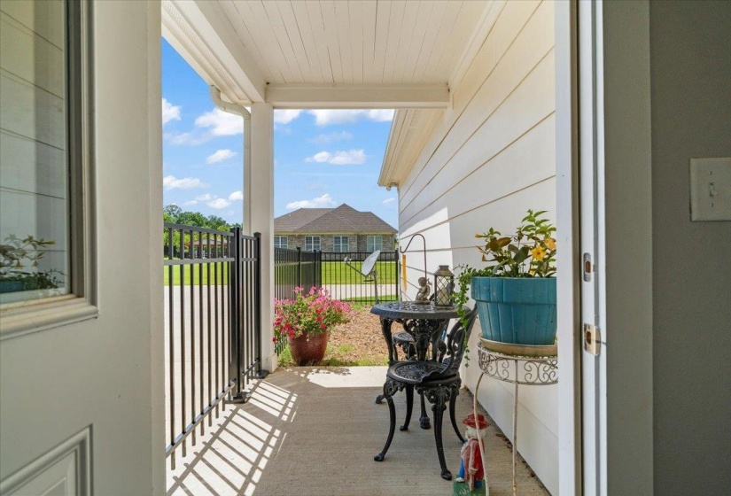 Back porch with concrete flooring and white siding