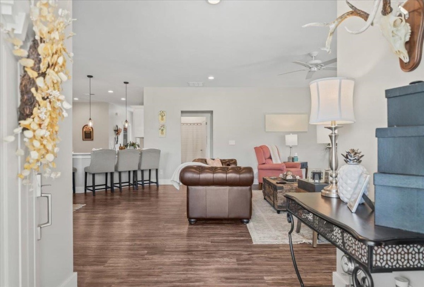 Open concept living area with wood-finish flooring