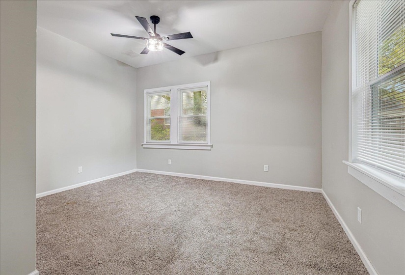 Empty room featuring carpet floors and ceiling fan