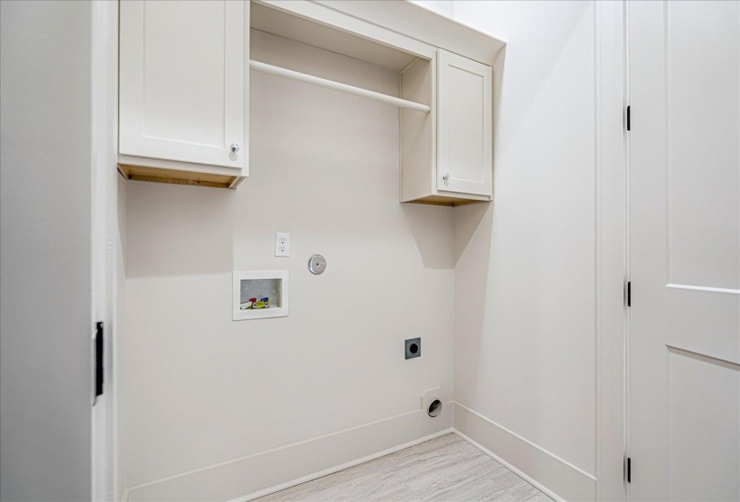 Laundry area featuring cabinet space, hookup for a washing machine, and hookup for an electric dryer