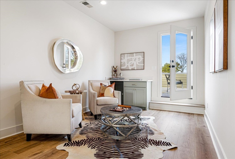 Sitting room with light wood-style flooring and recessed lighting