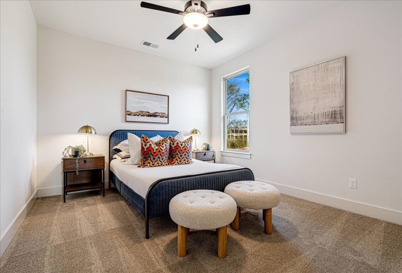 Carpeted bedroom featuring baseboards and ceiling fan