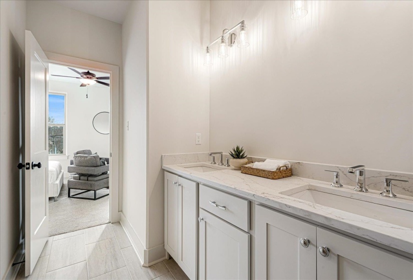 Bathroom with double vanity and ceiling fan