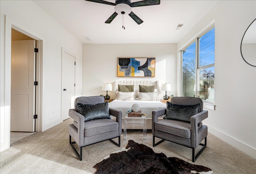 Bedroom featuring light carpet and a ceiling fan