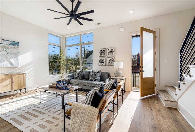 Living area featuring hardwood / wood-style flooring, a ceiling fan, and recessed lighting