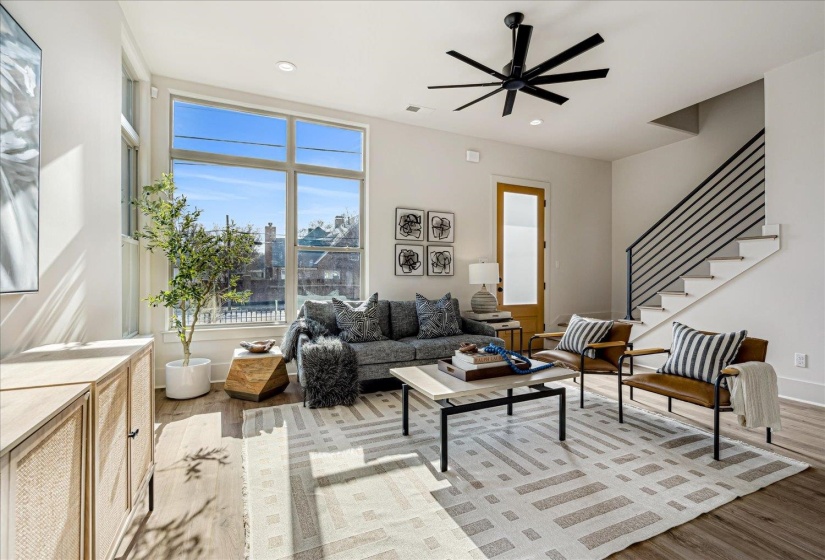 Living room featuring a ceiling fan, light wood-style flooring, and recessed lighting