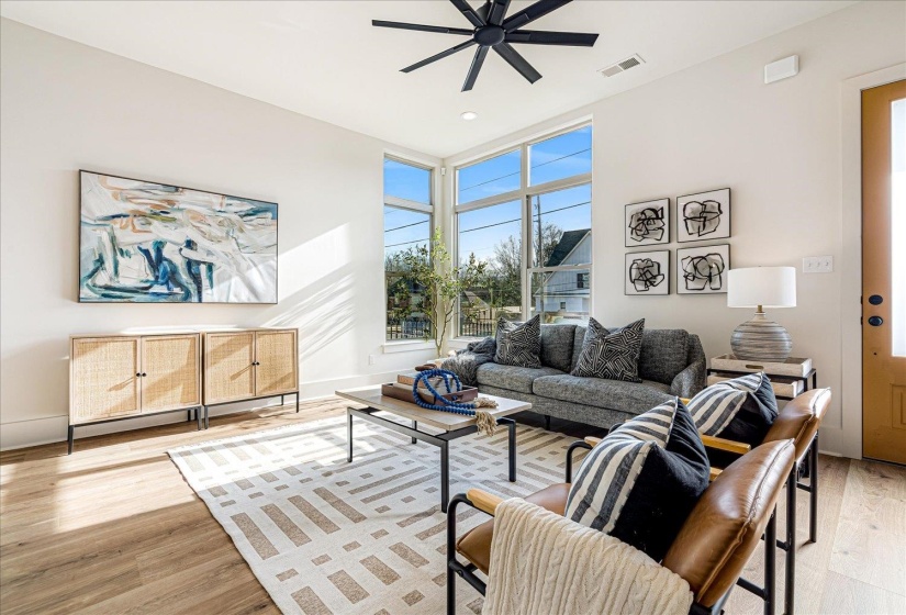 Living area featuring light wood finished floors and a ceiling fan