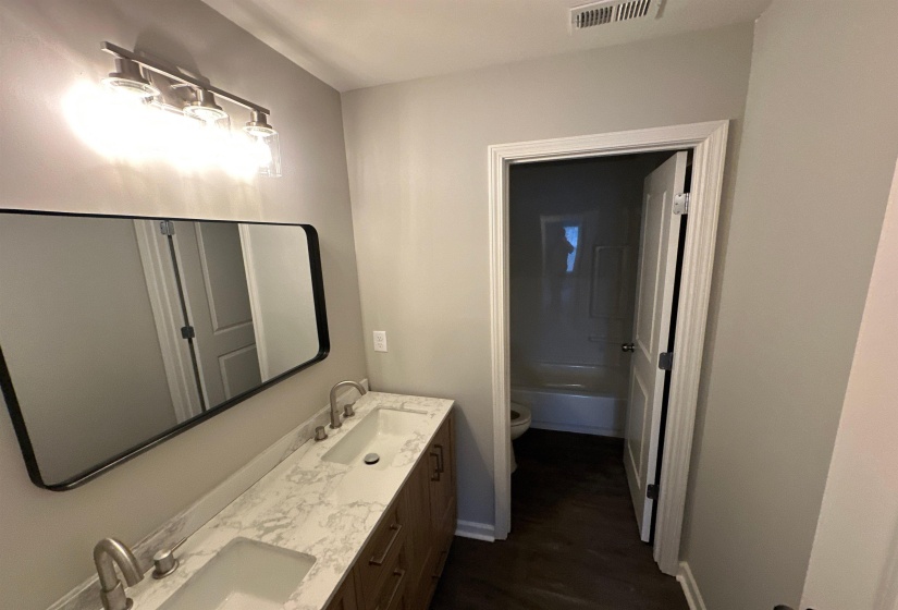Bathroom with double vanity and toilet