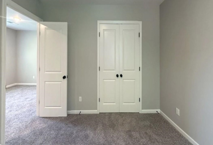 Unfurnished bedroom with carpet flooring and a closet